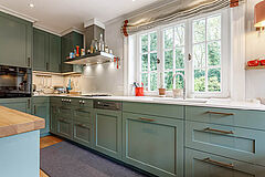 Landhausküche in Salbeigrün, Hamburg Altona | maßgefertigt von der Möbeltischlerei woodendesign – Fensterfront mit weißen Sprossenfenstern unterstreicht den Look