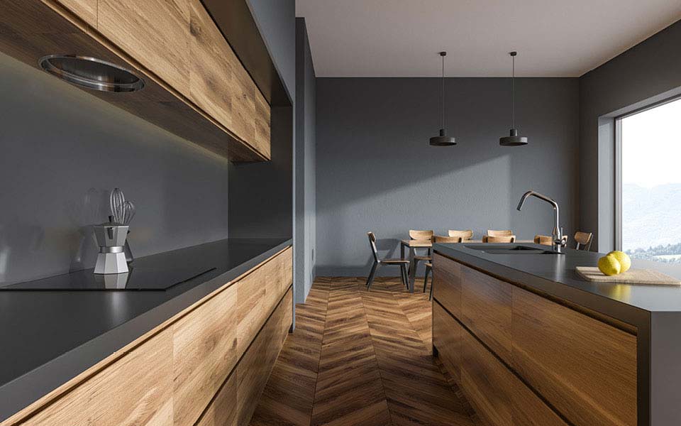 puristische Massivholzküche mit grauen Wänden und Küchenblock mit integriertem Spülbecken